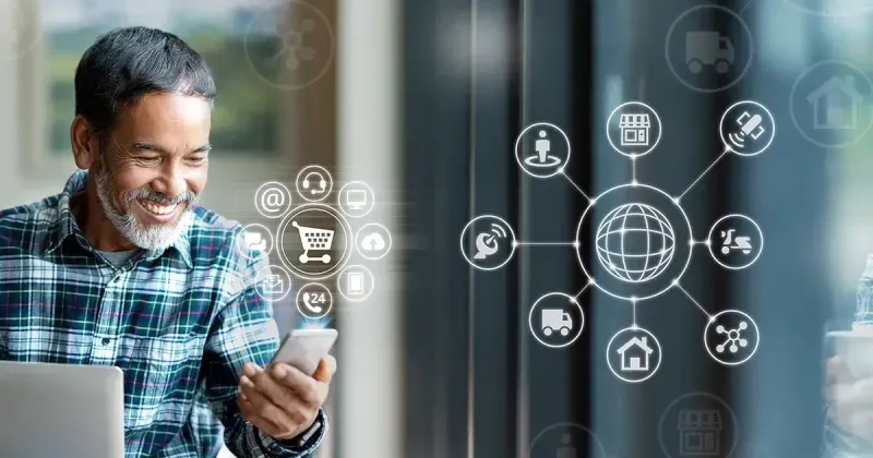 Man smiling while looking at a mobile device