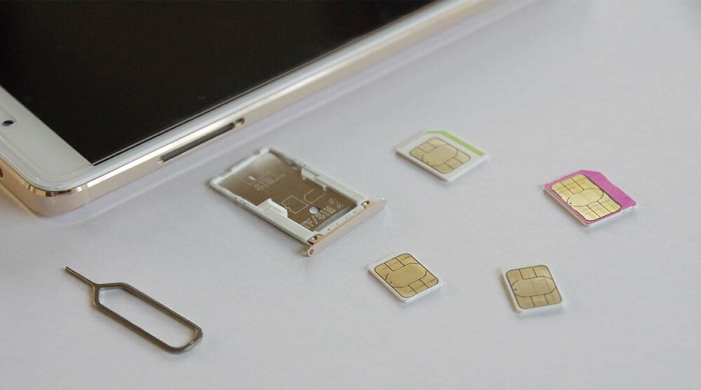 SIM cards sitting next to a phone to be inserted