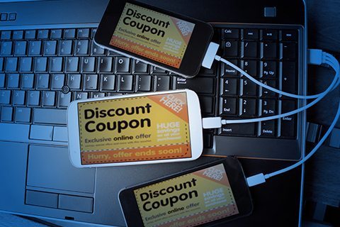 Discount coupon shown on three cell phones.