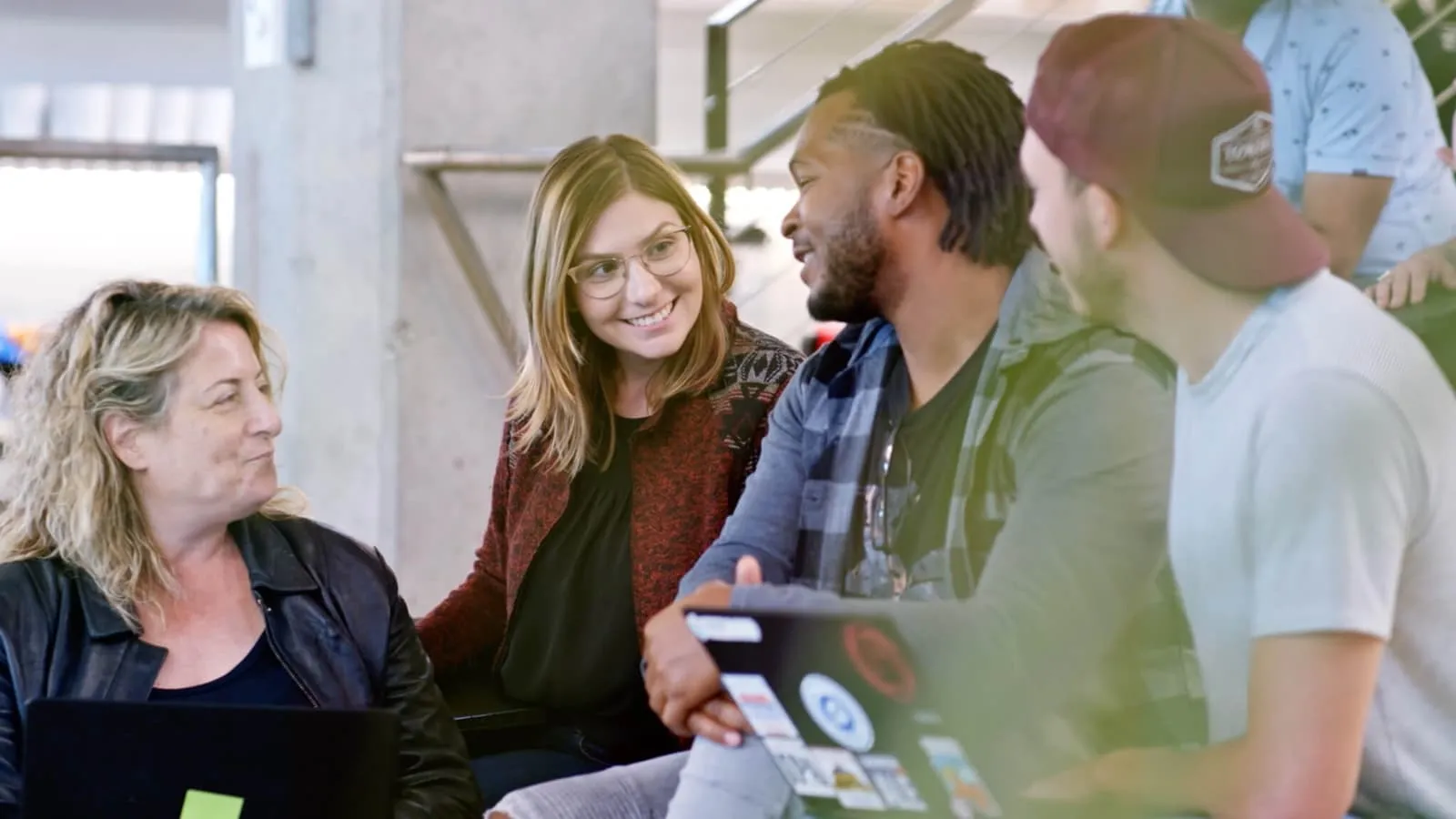 Group of friends / coworkers chatting and smiling