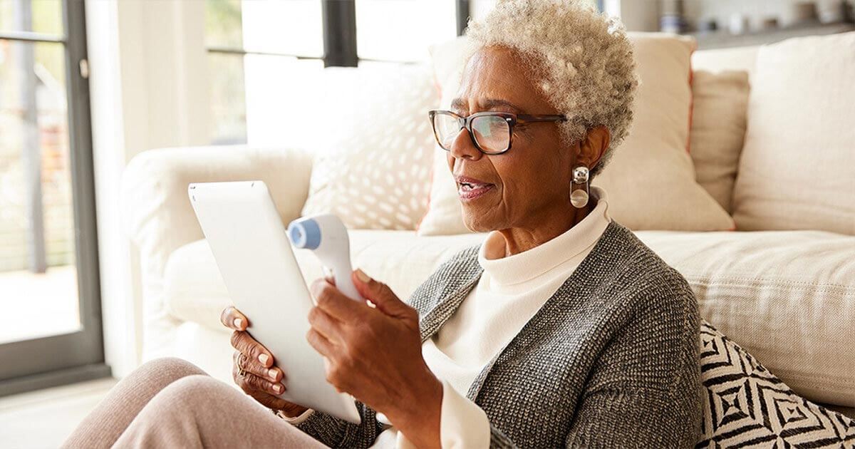 A woman using a tablet in her household.