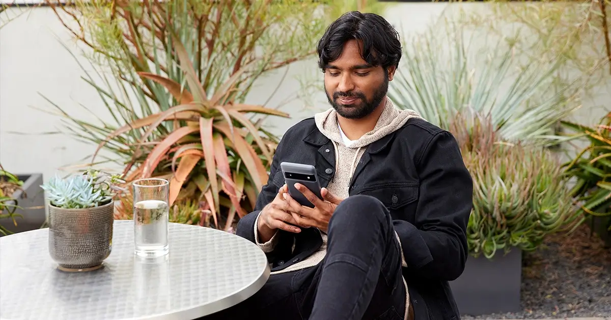 A man using a digital device in a cafe.