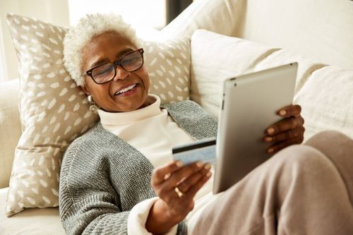 Woman sitting on couch doing some online shopping