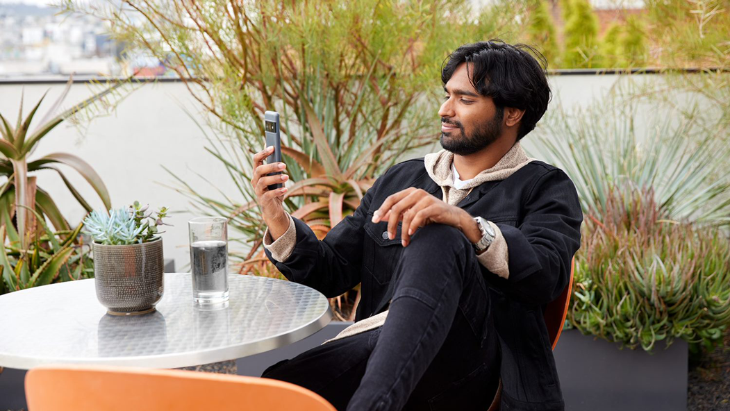 Man sitting outside looking at his phone